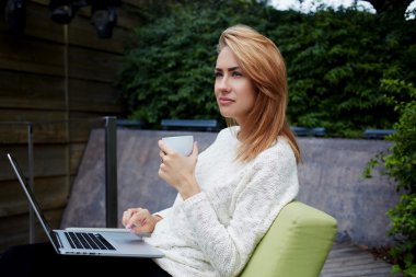 thoughtful female holding cup of tea
