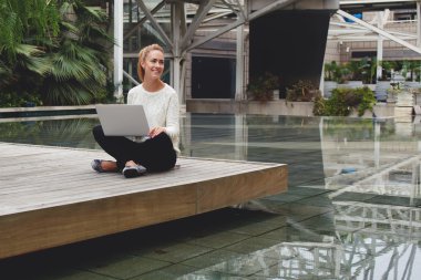 woman sitting with portable netbook