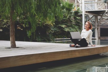 woman sitting with open laptop