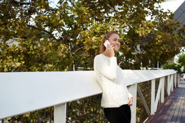 hipster girl having conversation via phone