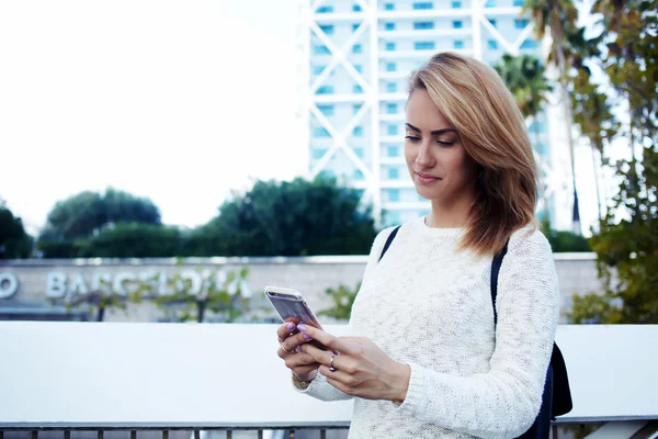 Charming woman watching on cell telephone — Stockfoto