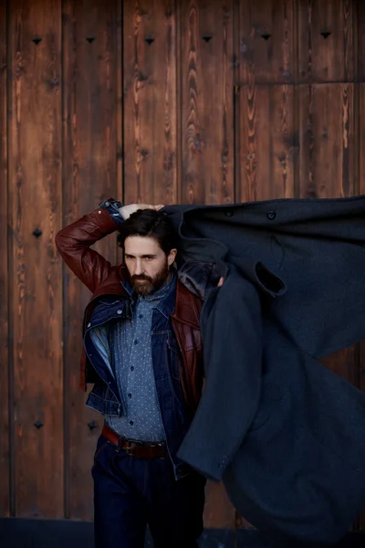 Man throws on the shoulders of coat — Stock Photo, Image