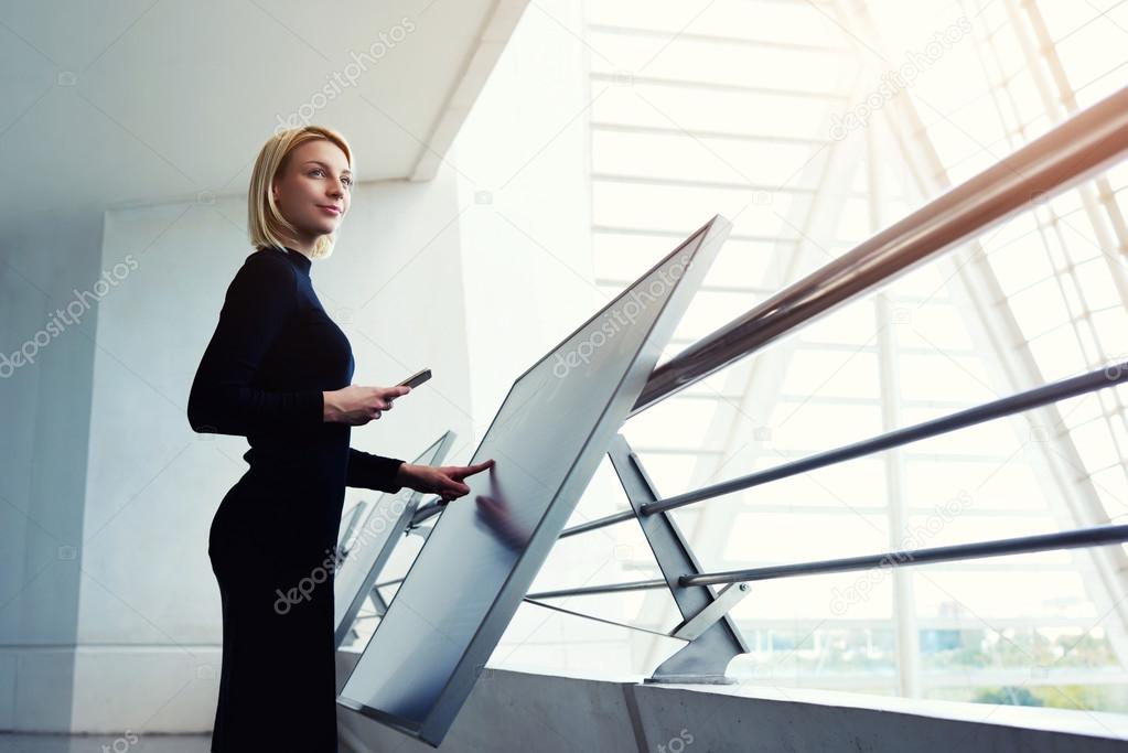 Young businesswoman using interactive display