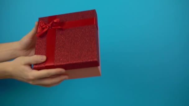 Geef van hand tot hand cadeau doos vakantie cadeau op kleur achtergrond, feest — Stockvideo