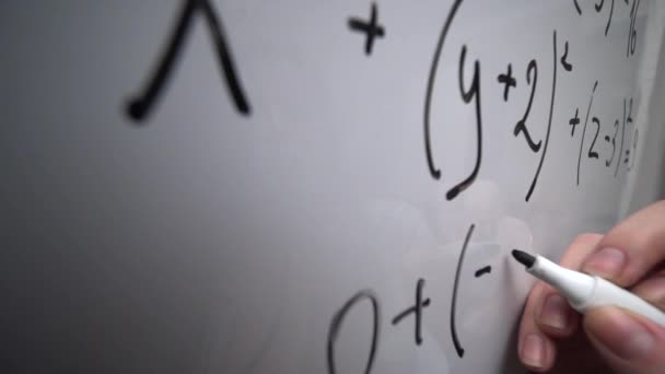 Writing mathematics equation on whiteboard, math formula, education concept — Vídeo de Stock