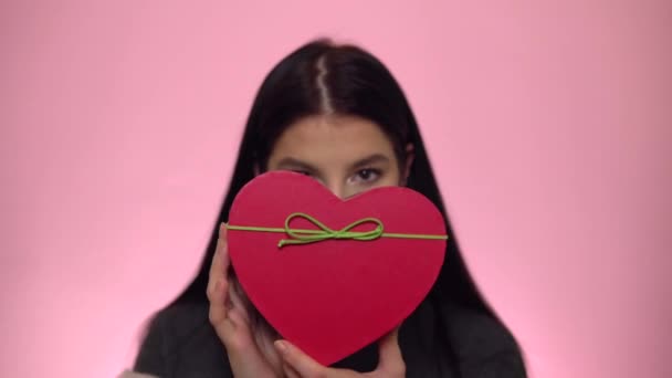 St. Valentijnsdag concept, Vrouw met hart aanwezig doos op roze achtergrond — Stockvideo