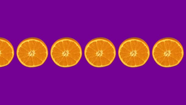 Oranges rotate, looped pattern on purple background — Stock Video