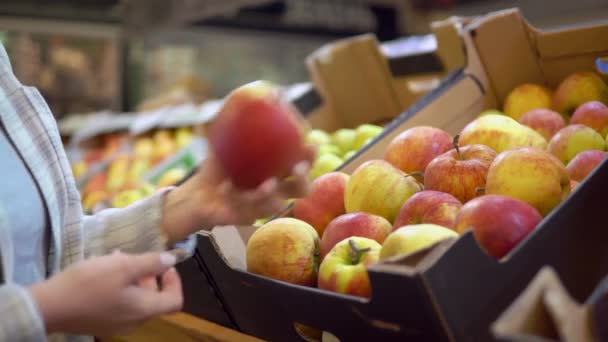 Een vrouw die appels koopt in de supermarkt. Geen afval, geen plastic concept. — Stockvideo