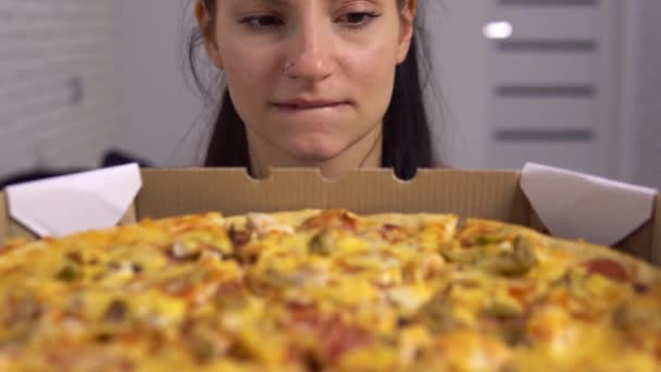Голодная женщина смотрит пиццу. Диетическая женщина теряет вес, зависимость от фаст-фуда — стоковое видео
