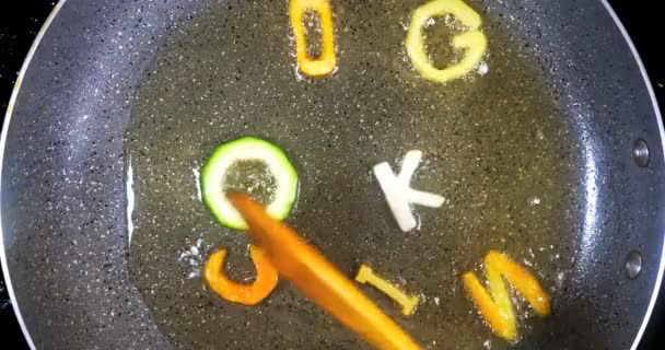 Stir-frying mixed alphabet letters, word cooking — Stock Video