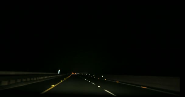 Speeding on motorway though small town at night — Stock Video