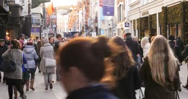 Crowd of anonymous people walking on busy Dublin street — Stock Video