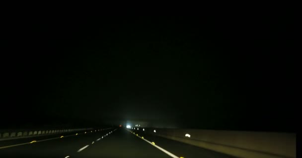 Speeding on motorway though small town at night — Stock Video