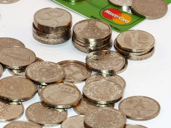 Bunch of coins with credit card — Stock Photo, Image