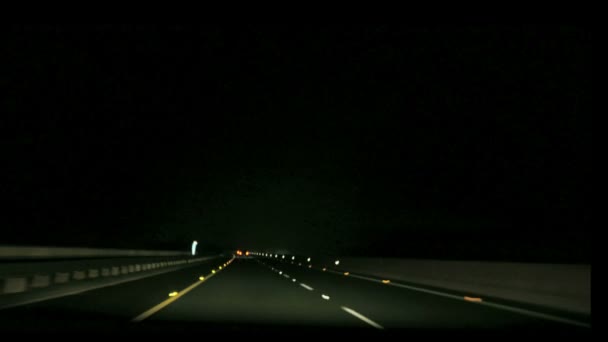 Speeding on motorway though small town in fog clouds at night — Stock Video