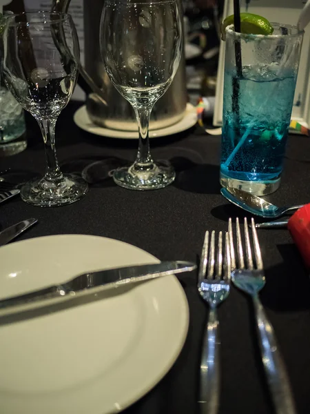 Wine glasses and plate on black background — Stock Photo, Image