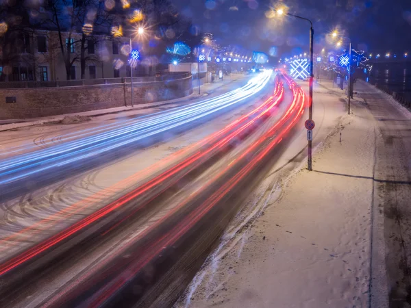 Car light at night on ice road in snow winter — Stock Photo, Image