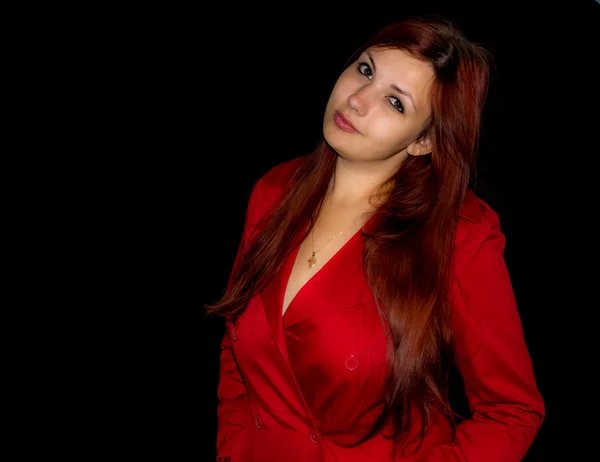 Studio photo of a pretty young woman in red coat — Stock Photo, Image