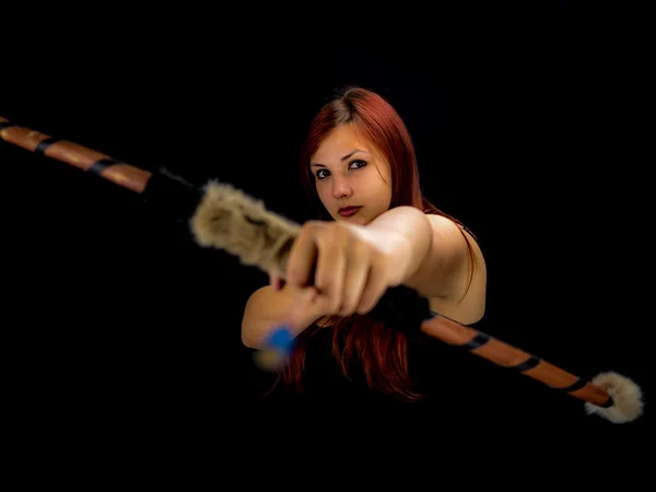 Beautiful archery woman aiming, black background Stock Image