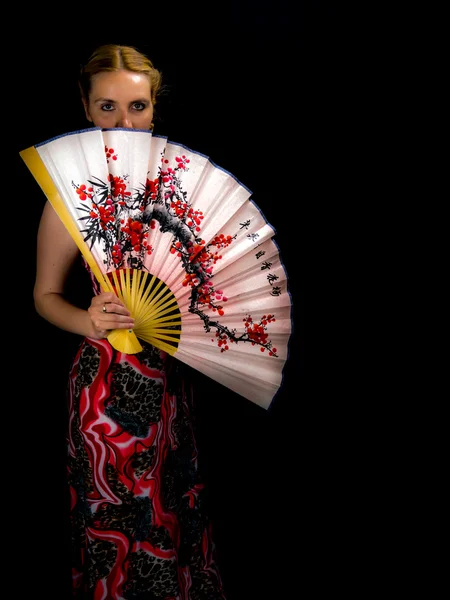 portrait of beautiful blonde woman with fan