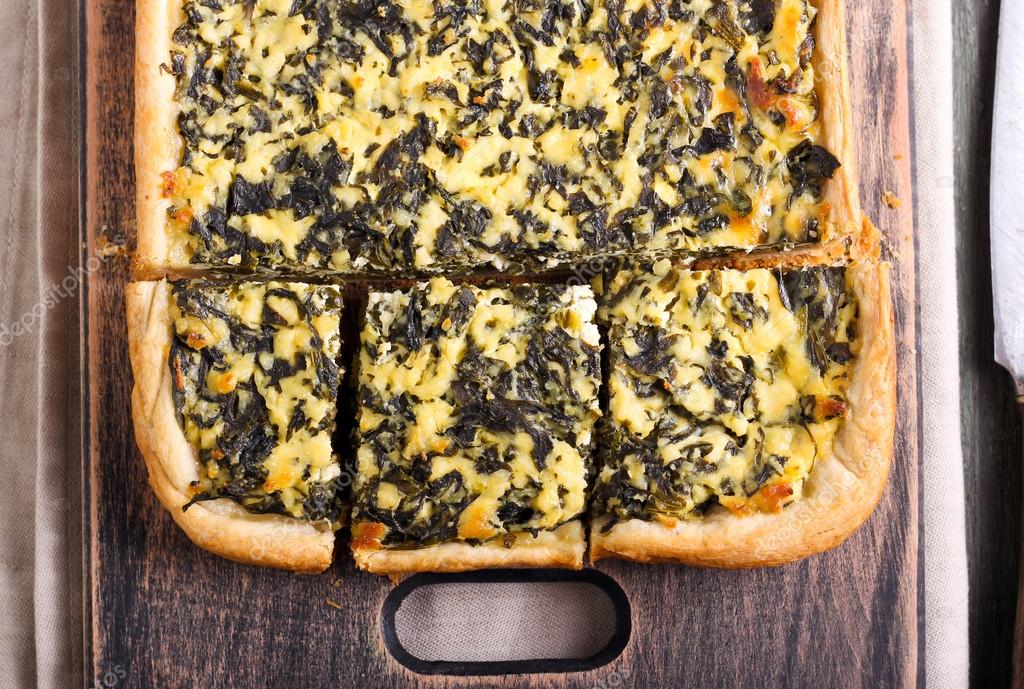Feta cheese and spinach puff pastry pie Stock Photo by ©manyakotic