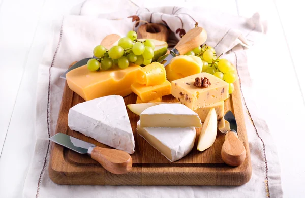 Many sorts of cheese with fruits — Stock Photo, Image