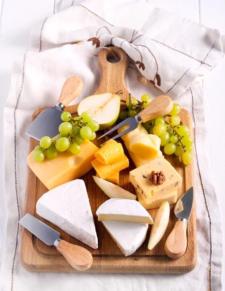 Many sorts of cheese with fruits — Stock Photo, Image