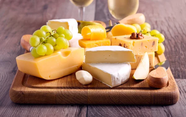 Many sorts of cheese with fruits — Stock Photo, Image