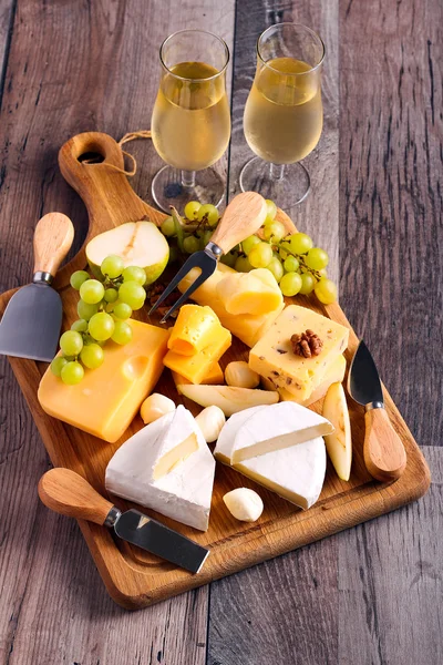 Many sorts of cheese with fruits — Stock Photo, Image