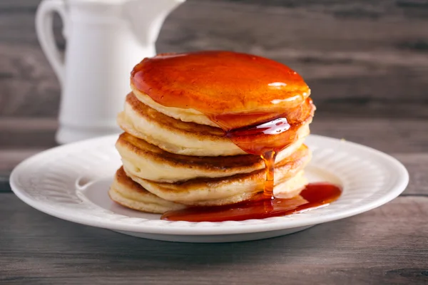 Honey over stack of pancakes — Stock Photo, Image