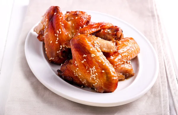 Flying chicken wings with sesame — Stock Photo, Image