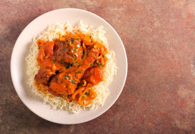 Baharatlı tavuk budu soslu pilav.