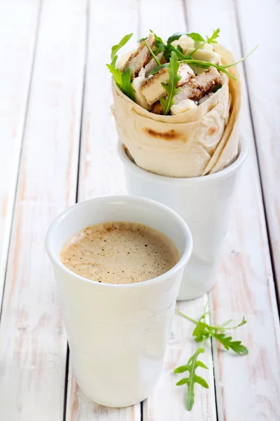 Mug of coffee and wrap roll — Stock Photo, Image