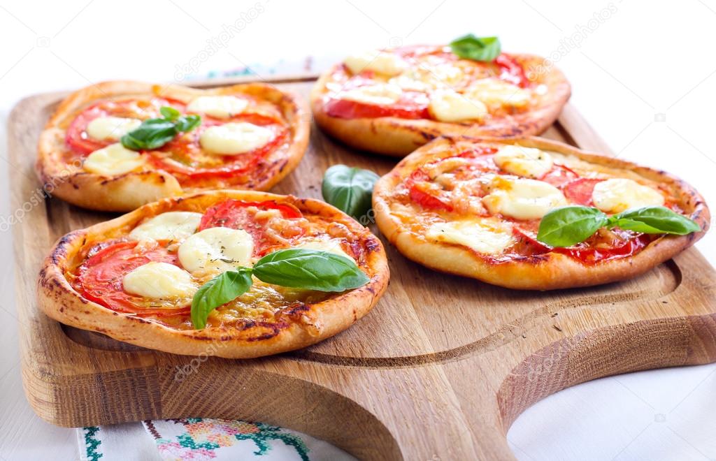 Tomato and mozzarella mini pizzas 