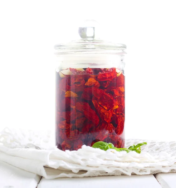 Sun dried tomatoes with herbs, seasonings in olive oil in a jar — Stock Photo, Image