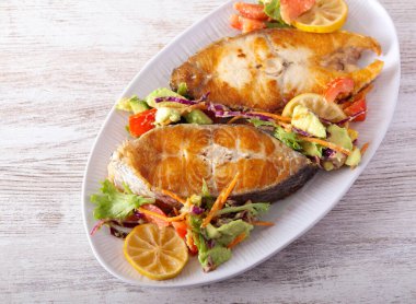 Perch steak, fried white fish with salad