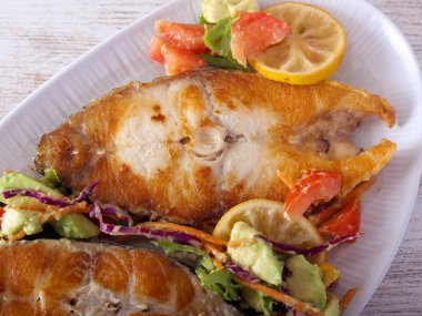 Perch steak, fried white fish with salad