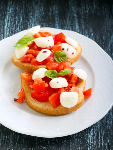 Mozzarella and tomato toasts — Stock Photo, Image