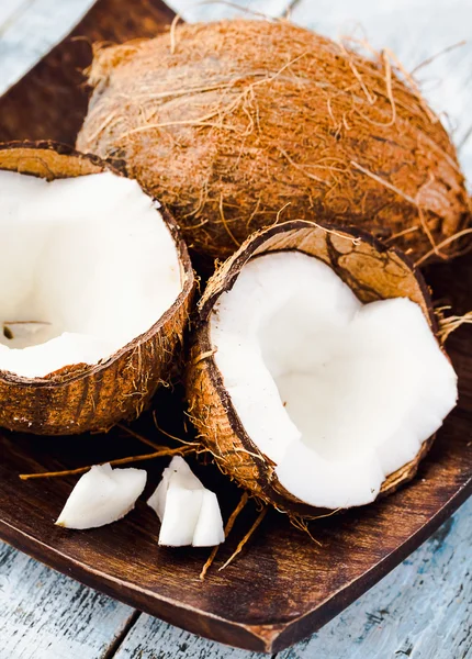 Fresh coconuts in the shell on a blue background — Stock Photo, Image