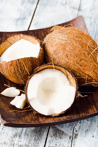 Fresh coconuts in the shell on a blue background — Stock Photo, Image