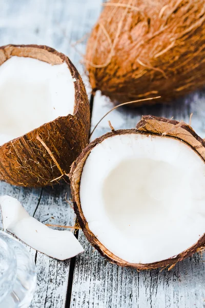 Fresh coconuts in the shell on a blue wooden background — Stock Photo, Image