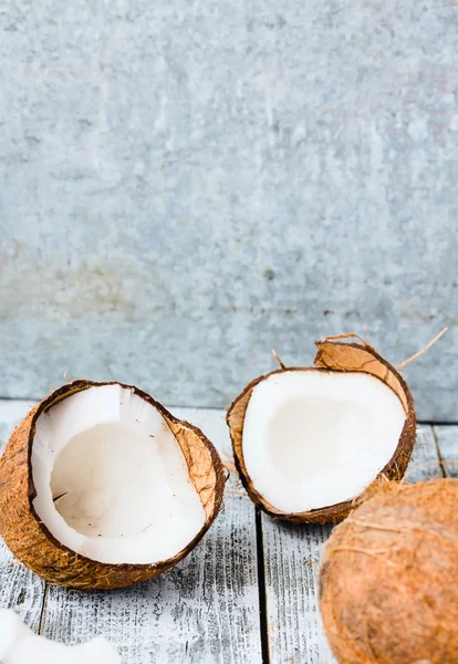 Fresh coconuts in the shell on a blue  wooden background — Stock Photo, Image