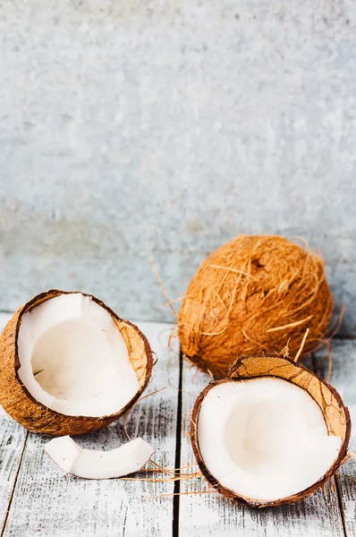 Fresh coconuts in the shell on a blue  wooden background — Stock Photo, Image