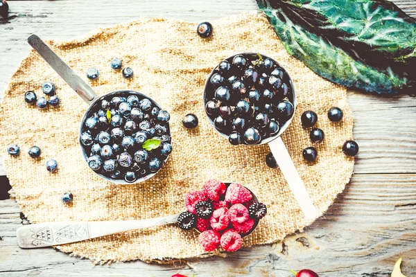 Fresh blueberries, currants and gooseberries, rustic, top view, — Stock Photo, Image