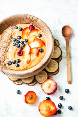 ahşap di şeftali, erik ve yaban mersini ile smoothie kase