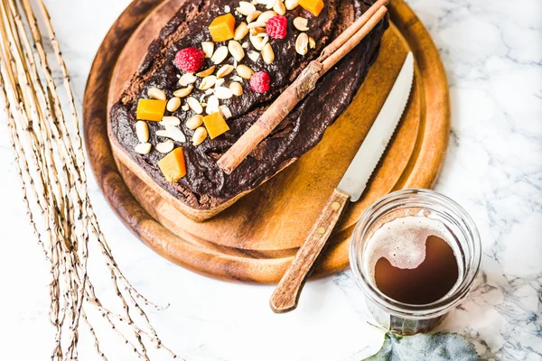 Chocolate cake with pumpkin, nuts and frosting, autumn baked — Stock Photo, Image