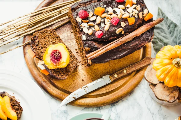 Kawałek czekoladowe ciasto z dyni, orzechów i świeże brzoskwinie, do — Zdjęcie stockowe