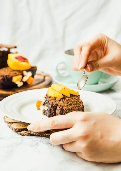 Piece of chocolate cake with pumpkin, nuts and fresh peaches — Stock Photo, Image