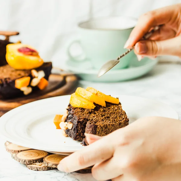 Piece of chocolate cake with pumpkin, nuts and fresh peaches — Stock Photo, Image