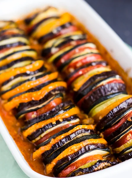 Ratatouille em caçarola branca sobre fundo escuro — Fotografia de Stock